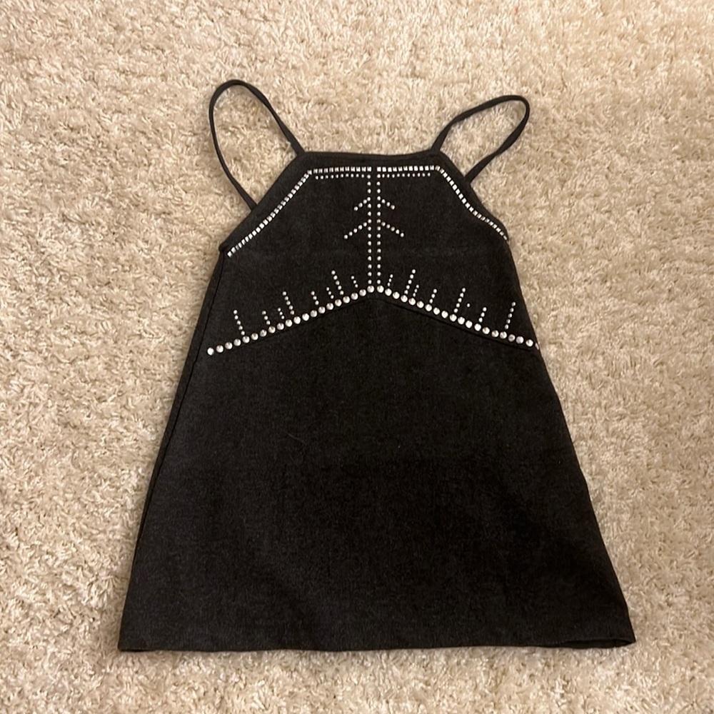 Beautiful Black jeweled dress suggested to be worn with a shirt underneath